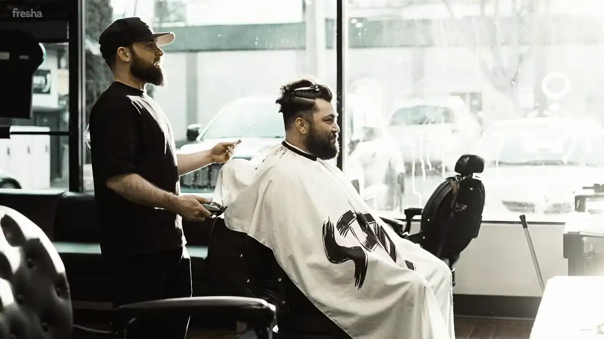 Barber working with client at mangROOMing